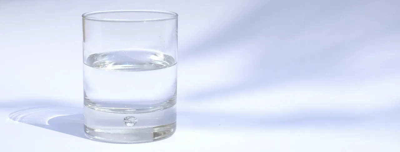 A glass of water filled exactly halfway: half full or half empty, depending on how you look at it